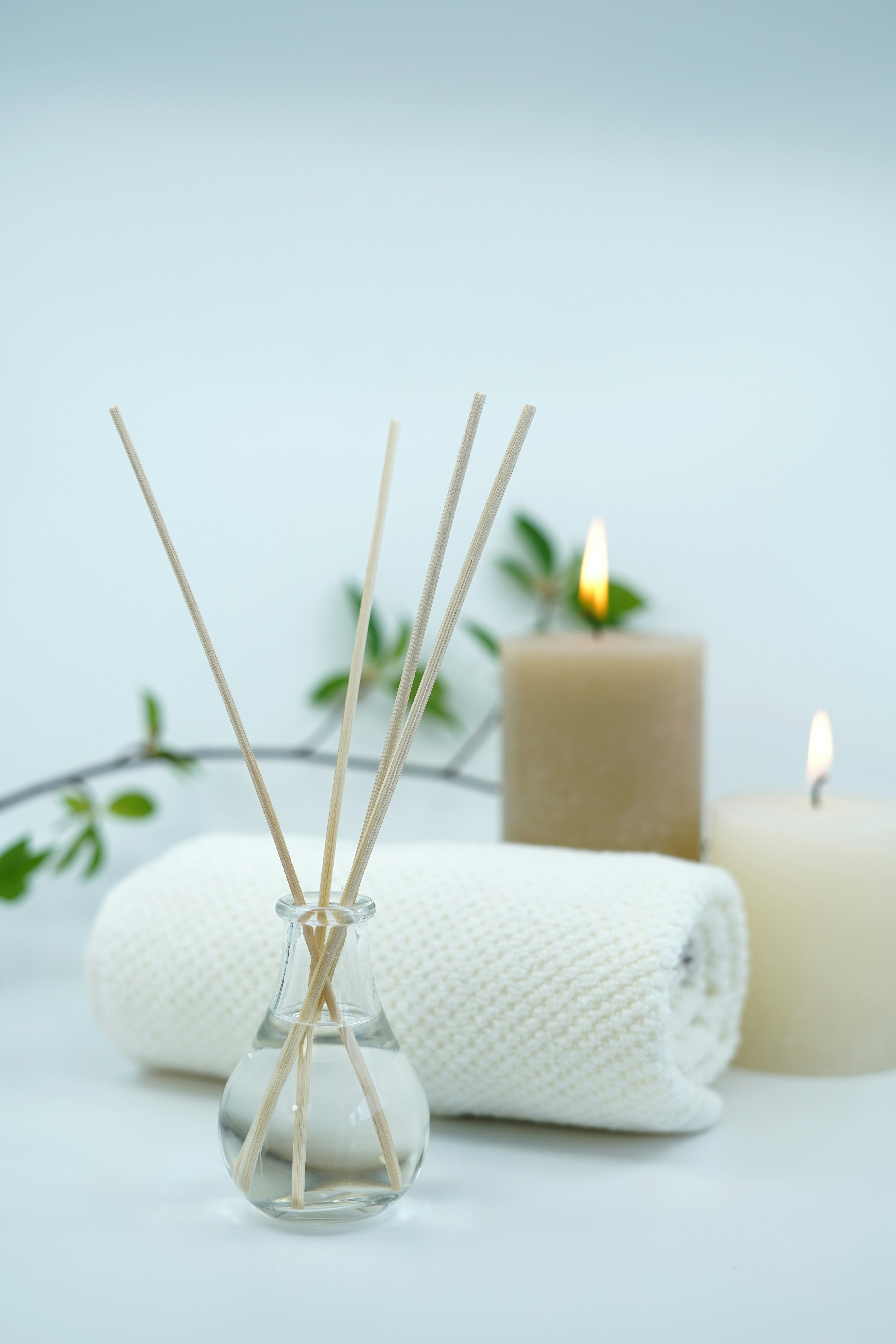 Aromatherapy sticks, candles, and towel creating a calming tantric massage setting.